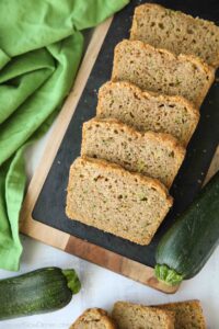 Slices of soft zucchini bread on a serving platter.