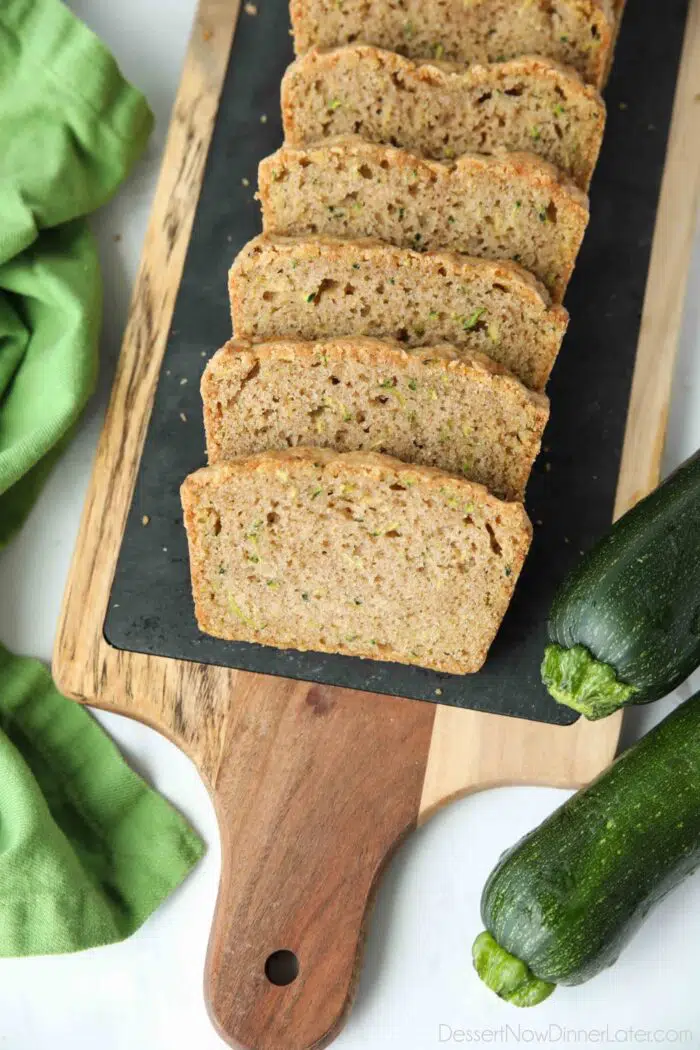 Slices of moist zucchini bread on a tray.