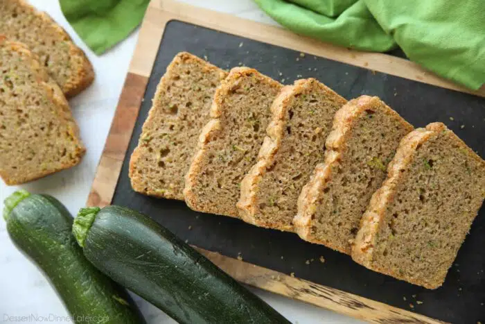 Sliced zucchini bread on a tray.