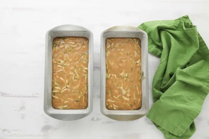 Zucchini bread batter in baking pans.