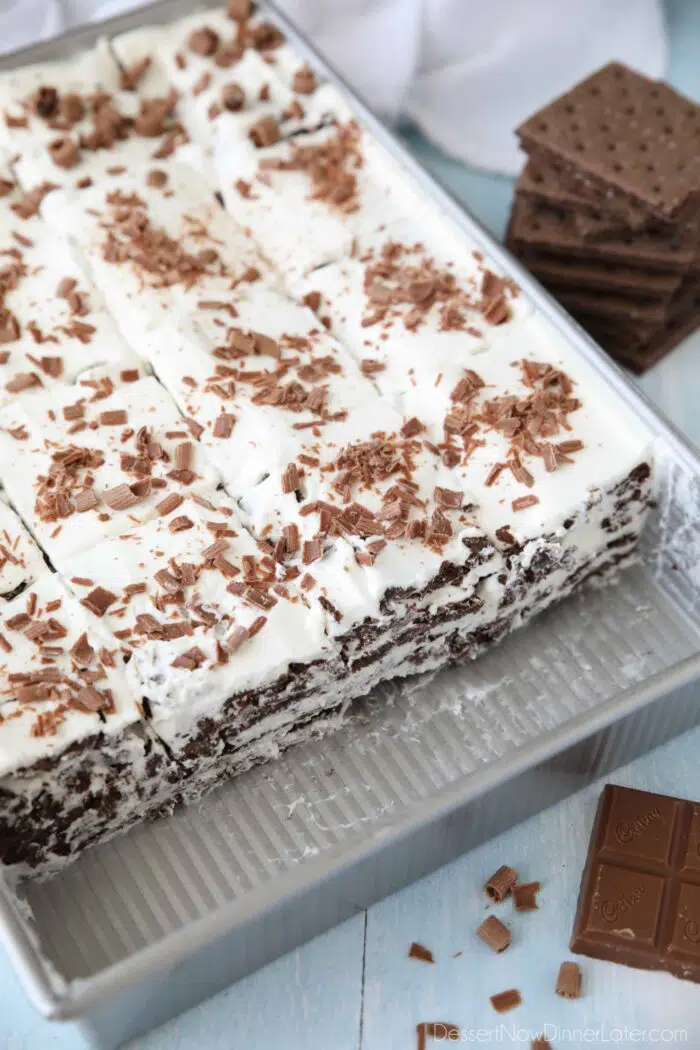 Pan of traditional icebox cake made from chocolate graham crackers and whipped cream.