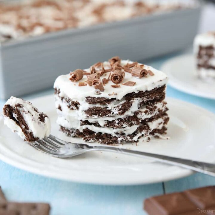 Icebox Cake with layers of chocolate graham crackers and whipped cream with chocolate curls on top.