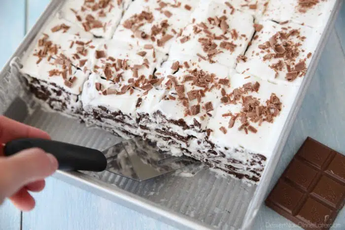 Pan of traditional icebox cake made from chocolate graham crackers and whipped cream.