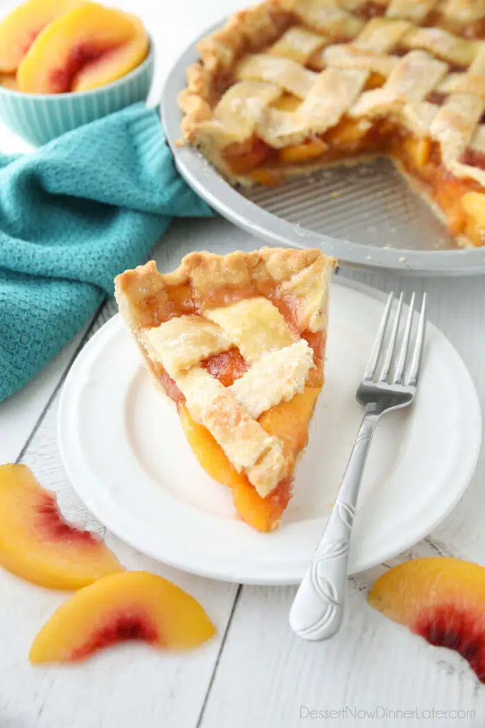 Slice of peach pie made with frozen peaches on a plate.
