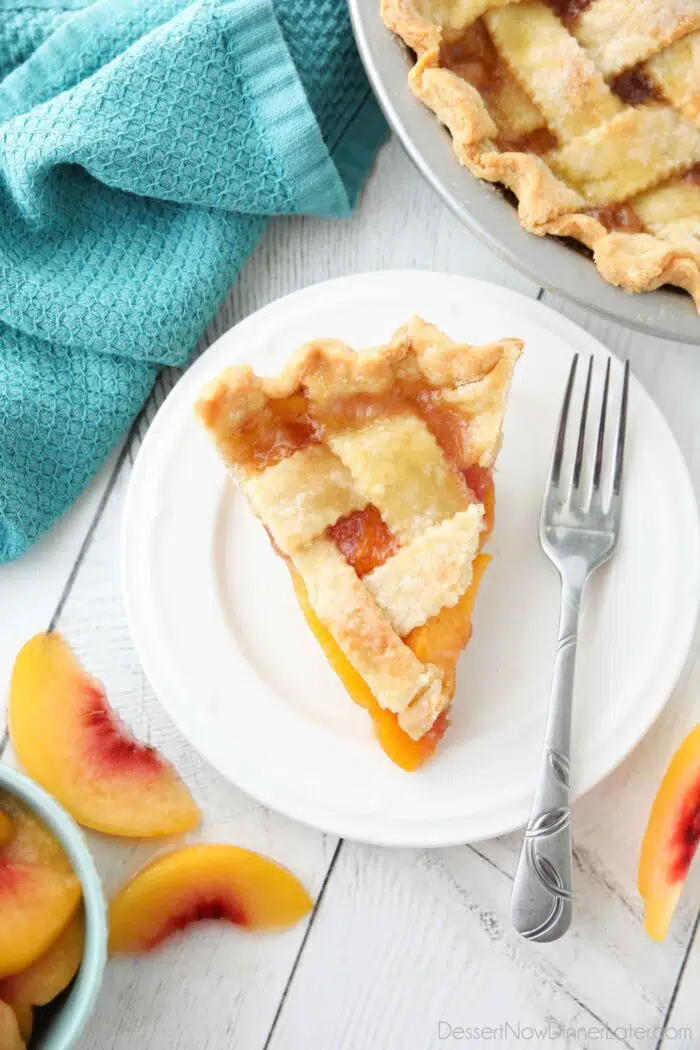 Slice of peach pie on a plate.