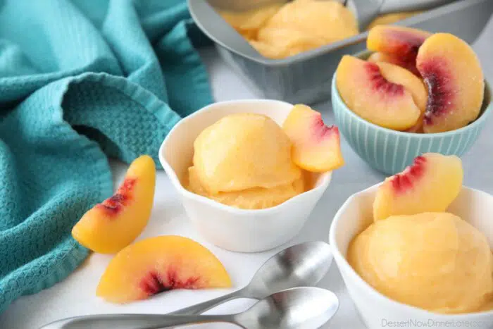 Three ingredient peach sorbet scooped into individual dishes.