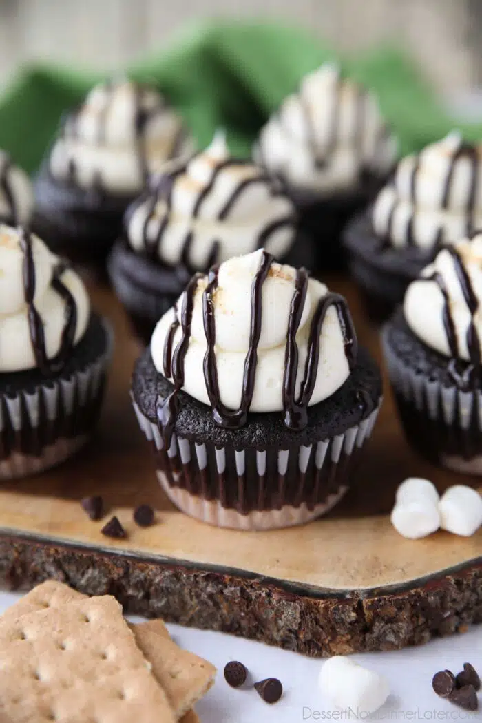 S'mores cupcakes with chocolate sauce drizzled on top.