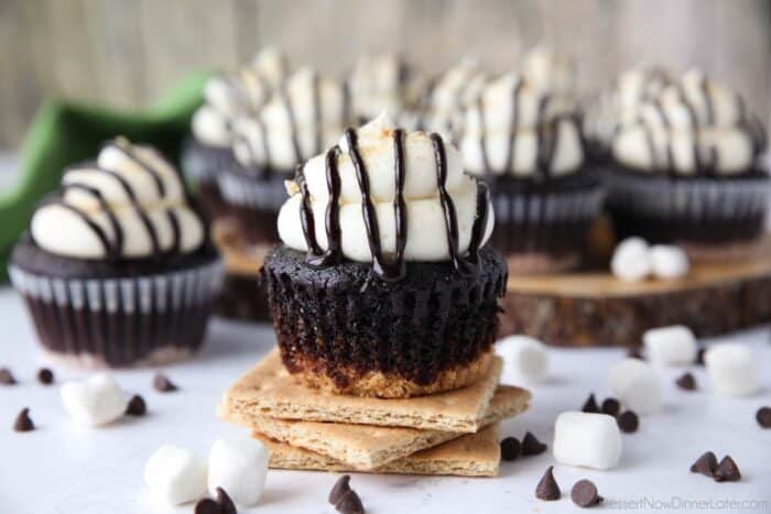 S'mores Cupcake with the wrapper down exposing chocolate cake and graham cracker crust.