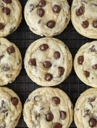 Baked chocolate chip cookies on wire cooling rack.