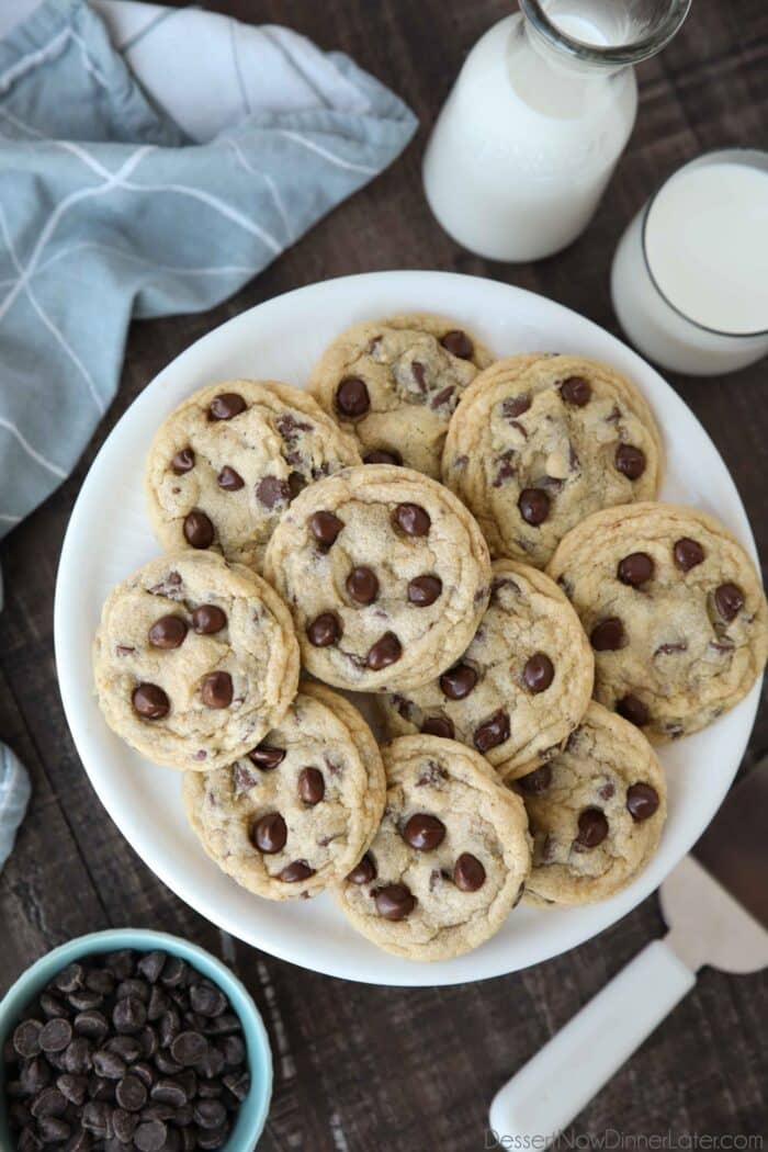 Warm chocolate chip cookies on a plate.
