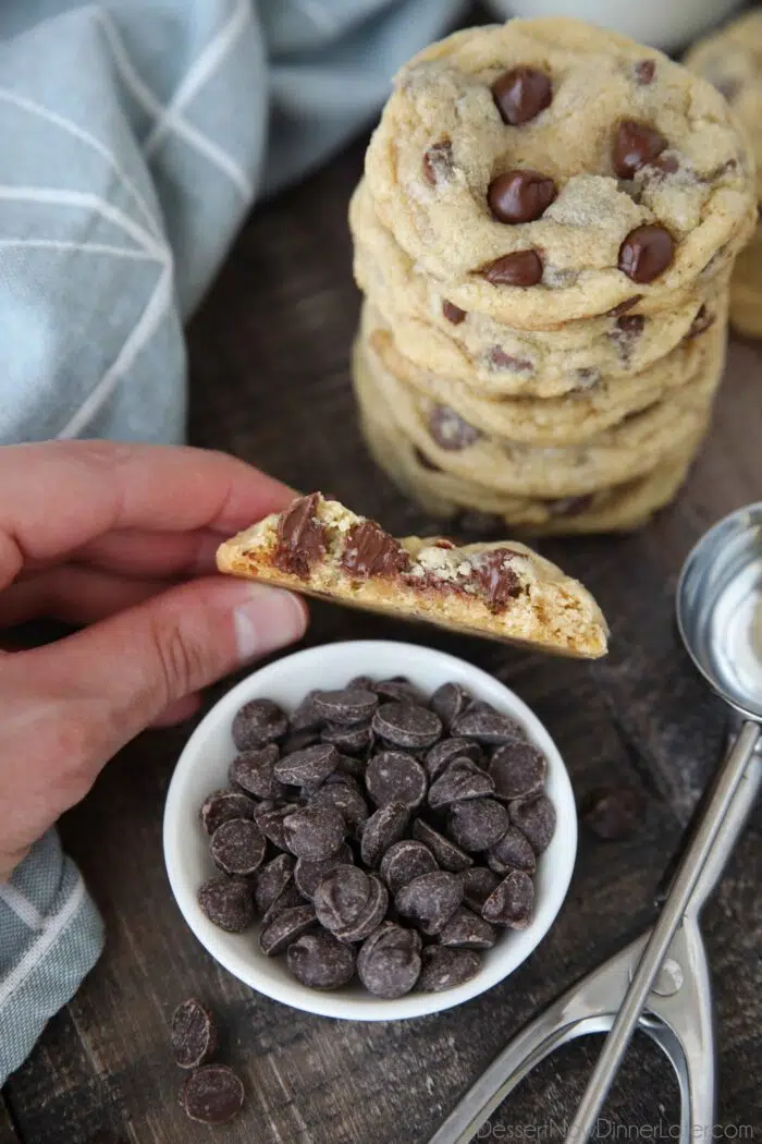 Cookie with a bite taken out showing melted chocolate chips inside.