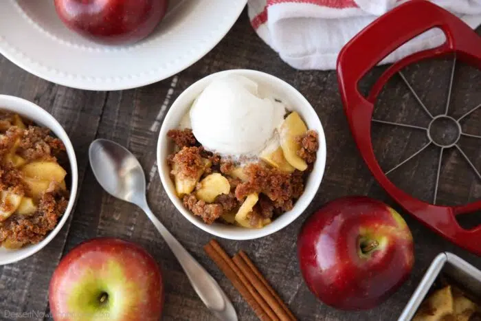 Bowl-full of apple brown betty topped with vanilla ice cream.