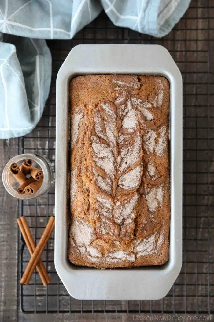 Top view of cinnamon-sugar swirled on top of a baked loaf cake.