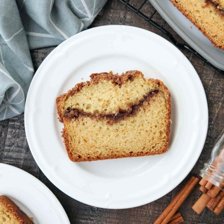 Slice of loaf cake with a cinnamon swirl center.