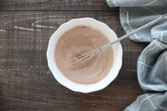 Bowl of cinnamon-sugar being whisked together.