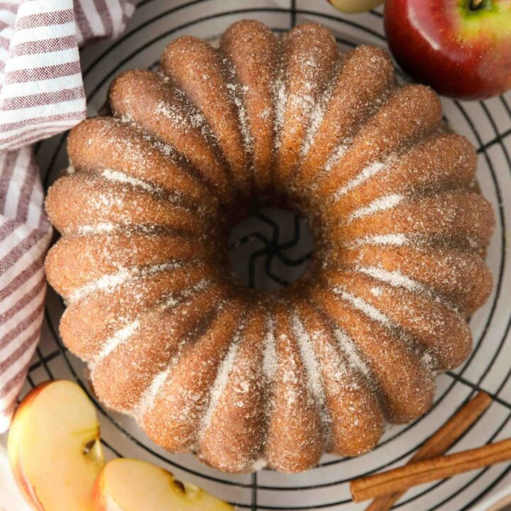 Top view of apple cider bundt cake with cinnamon-sugar sprinkled on the outside.