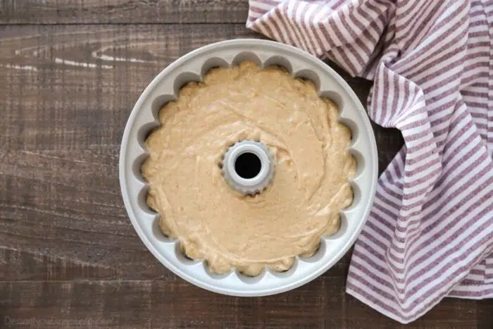 Top view of apple cider cake batter in a bundt pan.