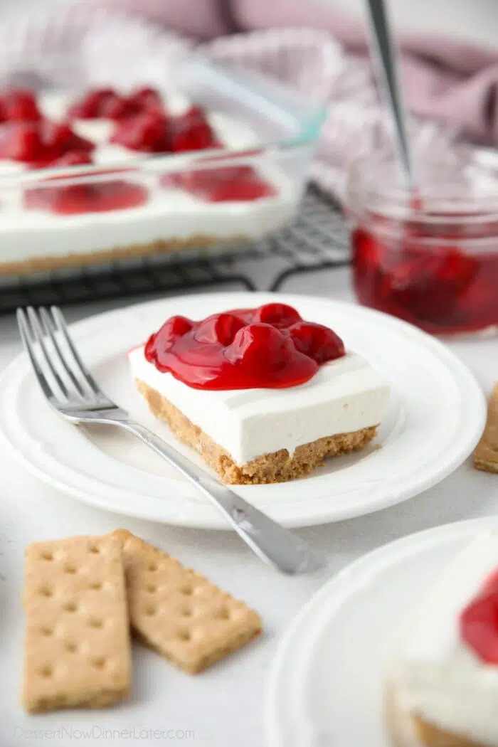 Slice of cherry delight no bake cheesecake on a plate.