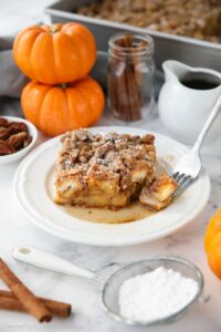 Piece of baked pumpkin French toast with a fork-full taken out.