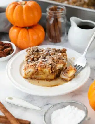 Piece of baked pumpkin French toast with a fork-full taken out.