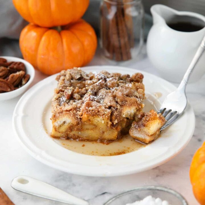 Piece of baked pumpkin French toast with a fork-full taken out.