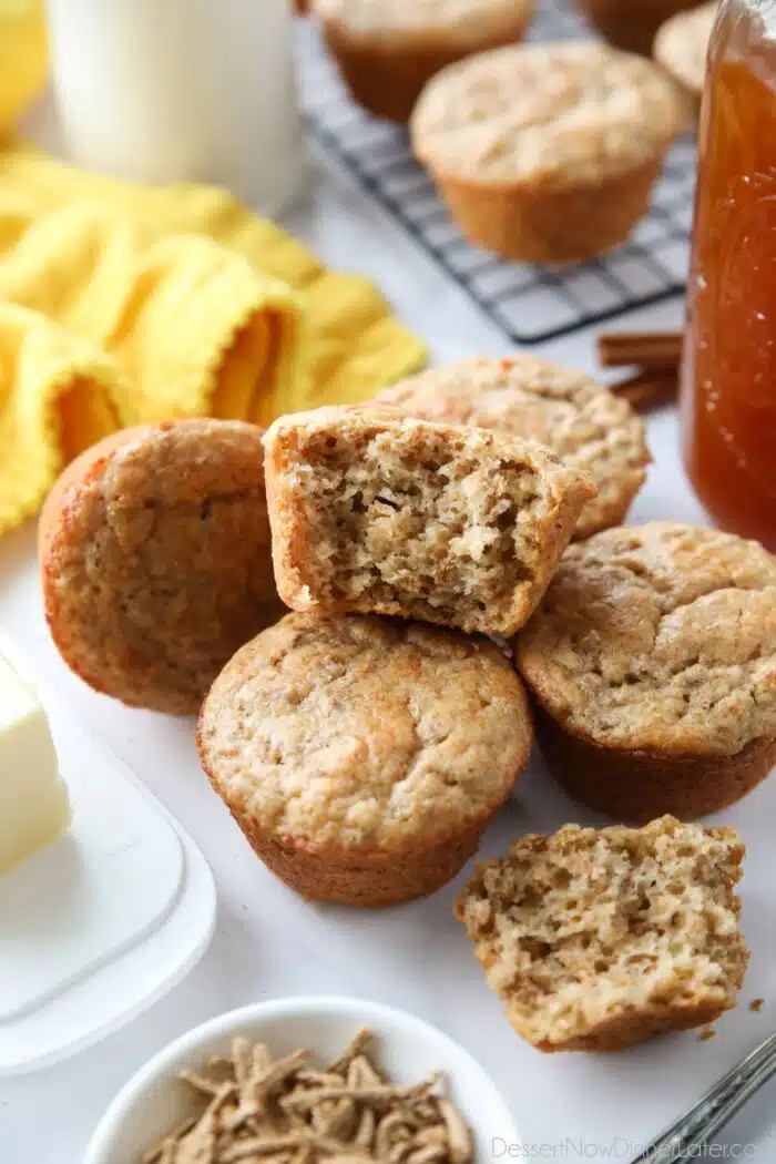 Bran muffins with one cut open, showing the fluffy inside texture.