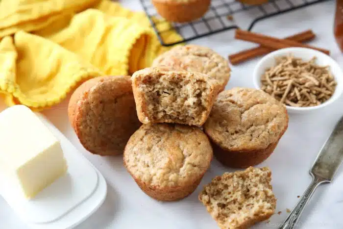 Muffins made with All-Bran cereal, with one muffin showing the light and fluffy interior texture.