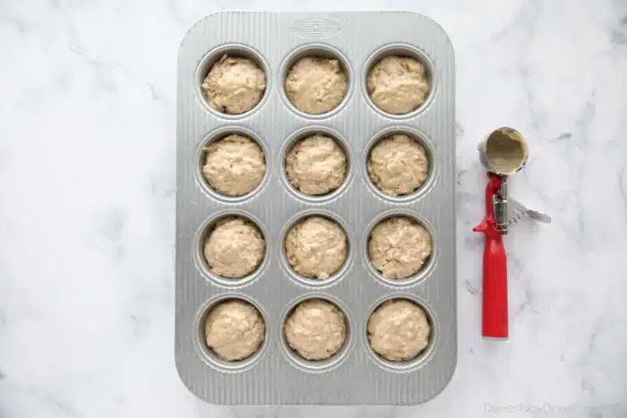 Bran batter scooped into a muffin tray.