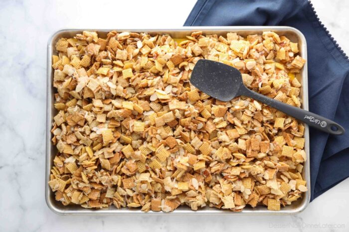 Coated cereal spread out on a sheet pan.