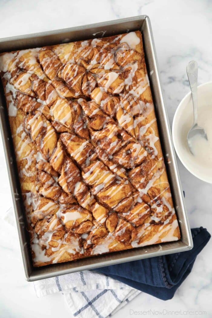 Top view of swirled cinnamon roll cake with a vanilla glaze drizzled over the top.