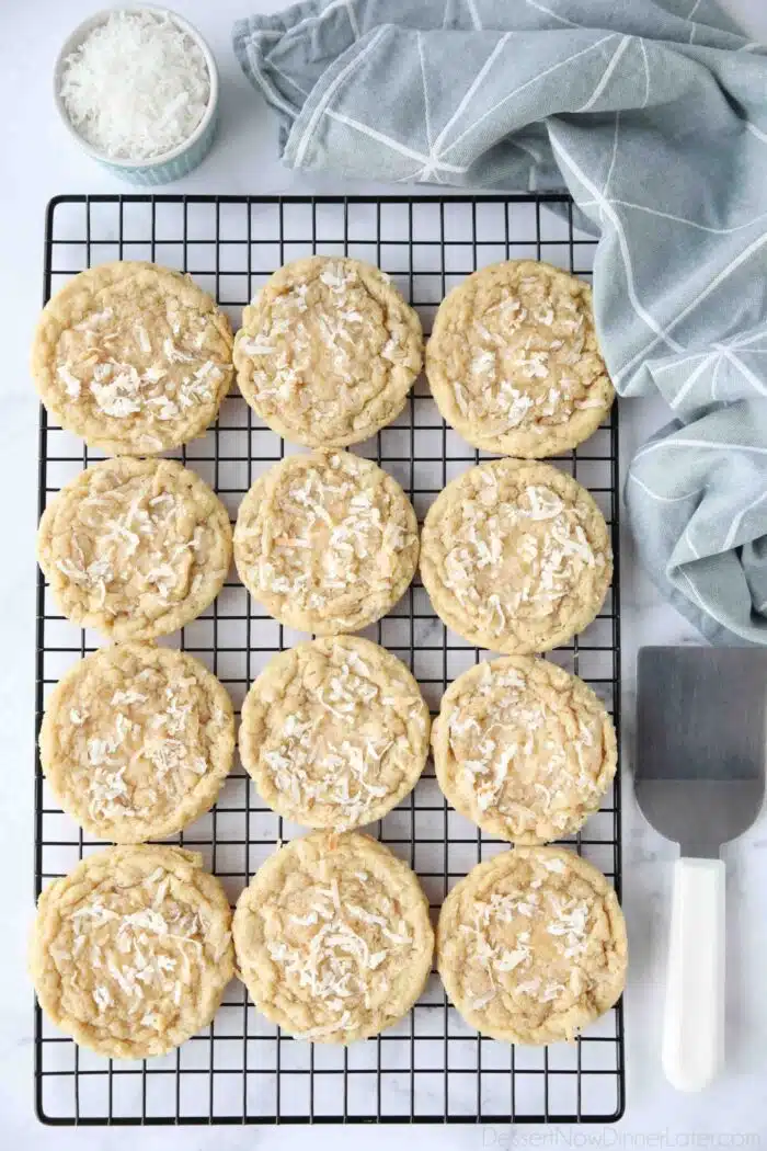 Coconut cookies cooling on a wire rack.