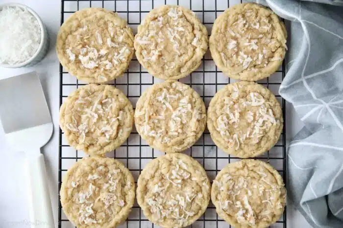 Coconut cookies cooling on a wire rack.