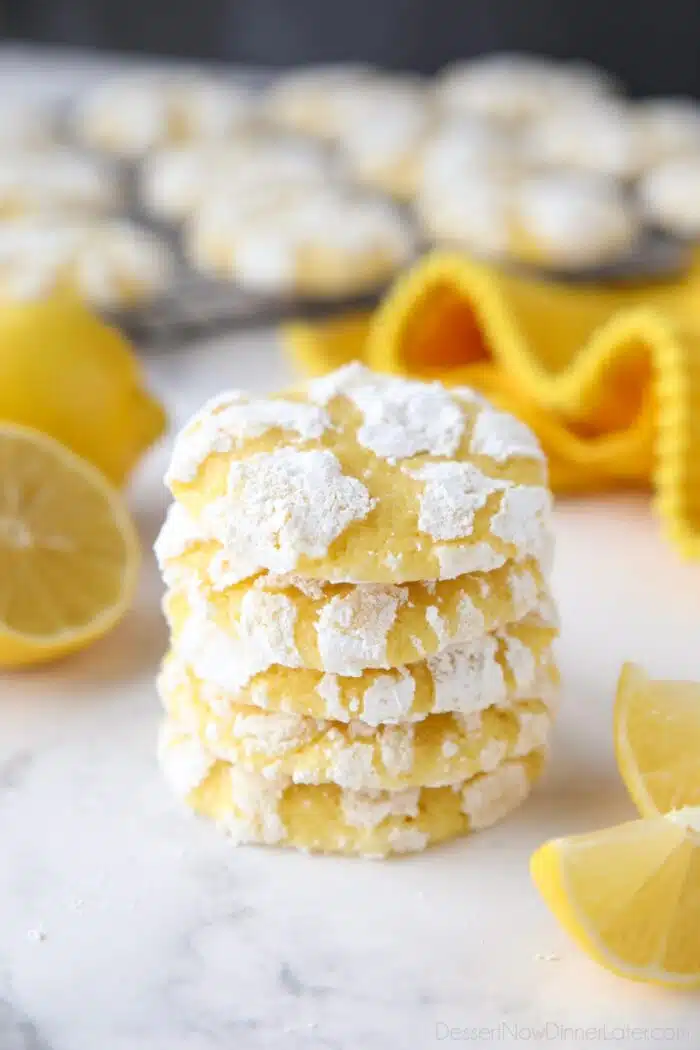 Stack of lemon crinkle cookies with powdered sugar on the outside.