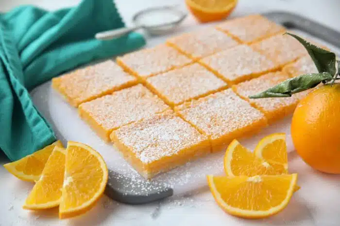 Side view of orange bars on a cutting board. (Like lemon bars, but with oranges.)
