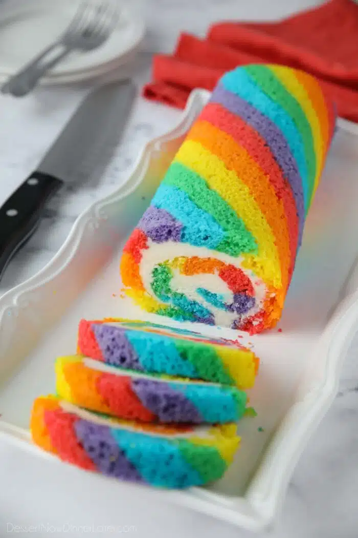 Rainbow Cake Roll with colored cake stripes and vanilla buttercream filling.