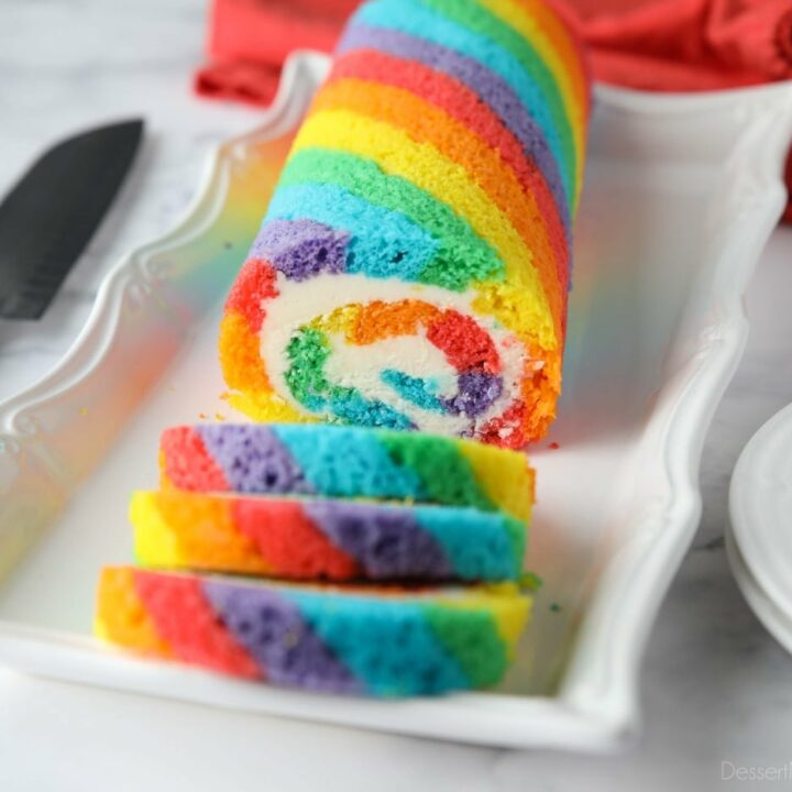 Rainbow Cake Roll with colored cake stripes and vanilla buttercream filling.