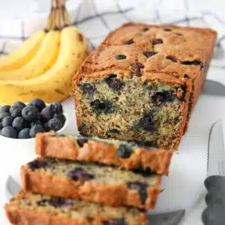 Loaf of banana blueberry bread cut open to show the inside.