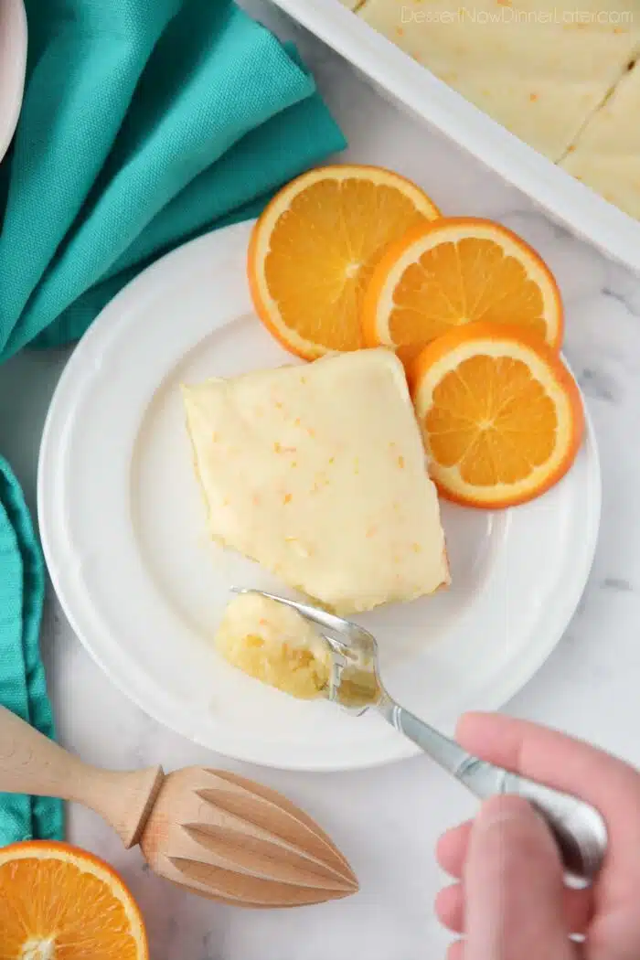 Fork full of orange brownies ready to be eaten.