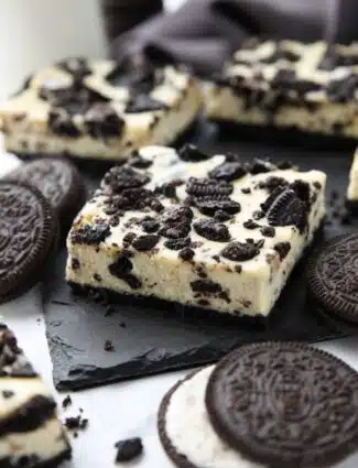 Close up of Oreo cheesecake bars with more Oreos.