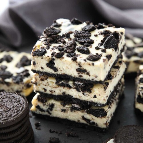 Three Oreo cheesecake bars stacked together.