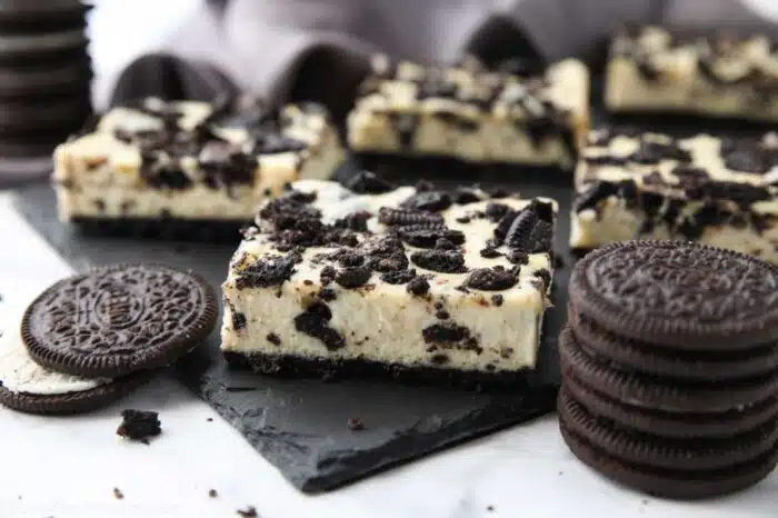 Close up of Oreo cheesecake bars with more Oreos.