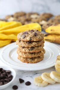 Stack of banana oatmeal chocolate chip cookies on a plate.