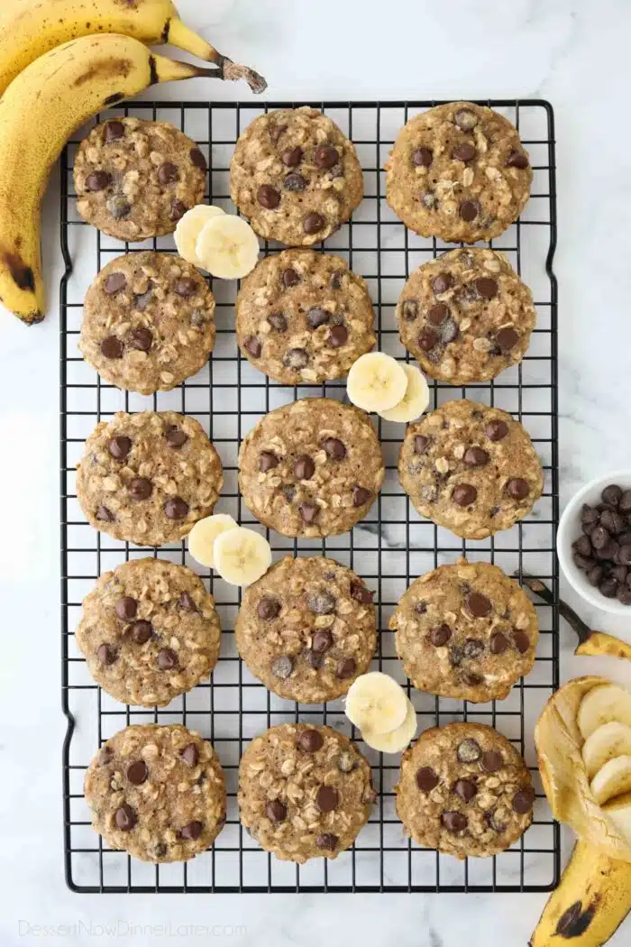 Banana oatmeal chocolate chip cookies on a wire cooling rack.