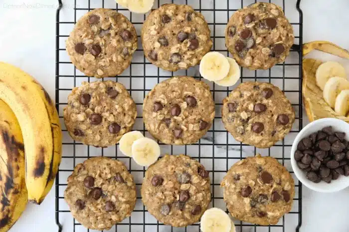 Banana oatmeal chocolate chip cookies on a wire cooling rack.