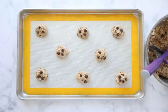 Unbaked banana oatmeal cookie dough balls with chocolate chips on top.