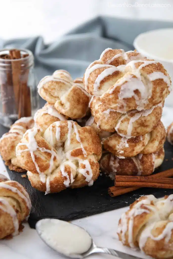 Stack of cinnamon knots with icing drizzled on top.