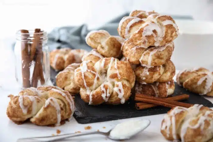Stack of cinnamon knots with icing drizzled on top.