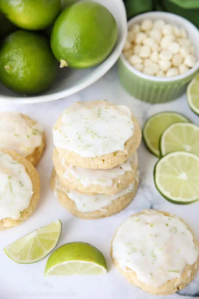 Stack of key lime cookies with white chocolate chips and a lime glaze.