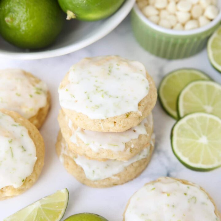 Stack of key lime cookies with white chocolate chips and a lime glaze.