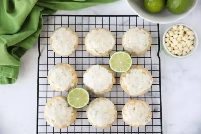 Top view of key lime cookies with glaze on wire cooling rack.